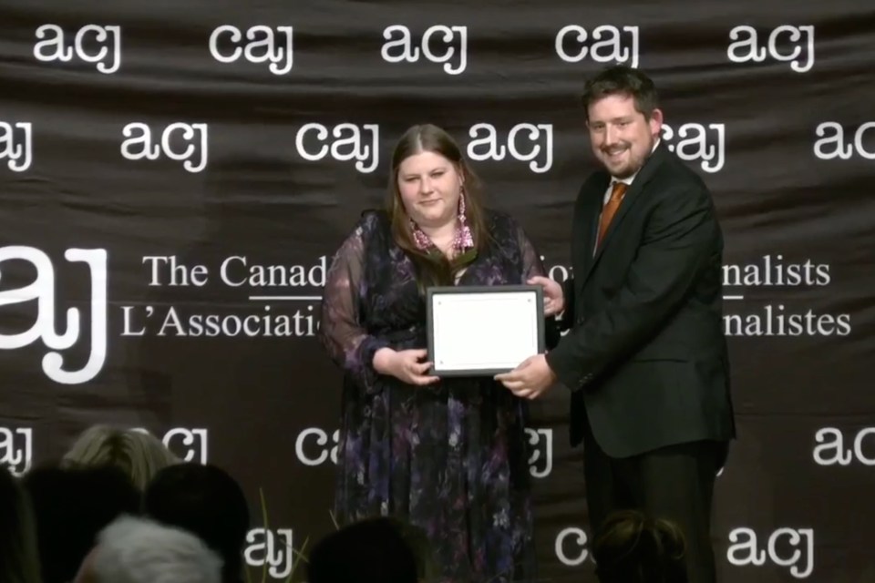 Cabin Radio's Emily Blake, left, and Ollie Williams receive an award in a still from a Canadian Association of Journalists live stream.